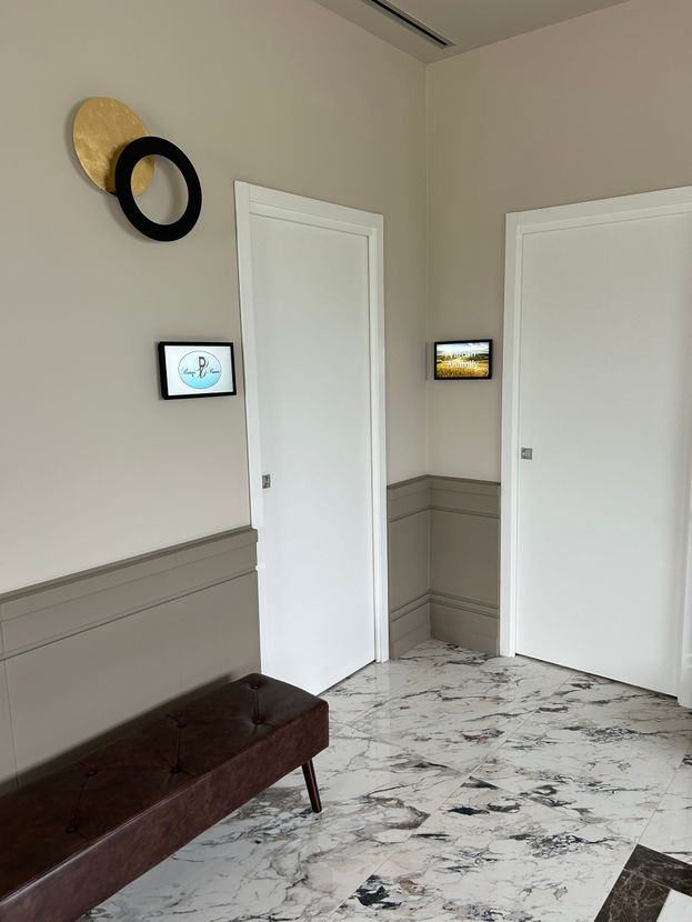 Un corridoio con una panca e un quadro sul muro con la scritta 