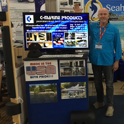 Founder Mike Celoni stands in front of a c-marine products display