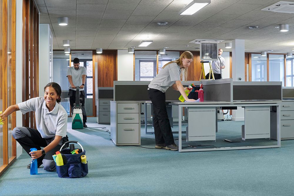 A group of people are cleaning an office.