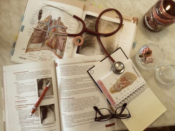 Literature scattered on a desk with a stethoscope on top. Representing medicare on this website