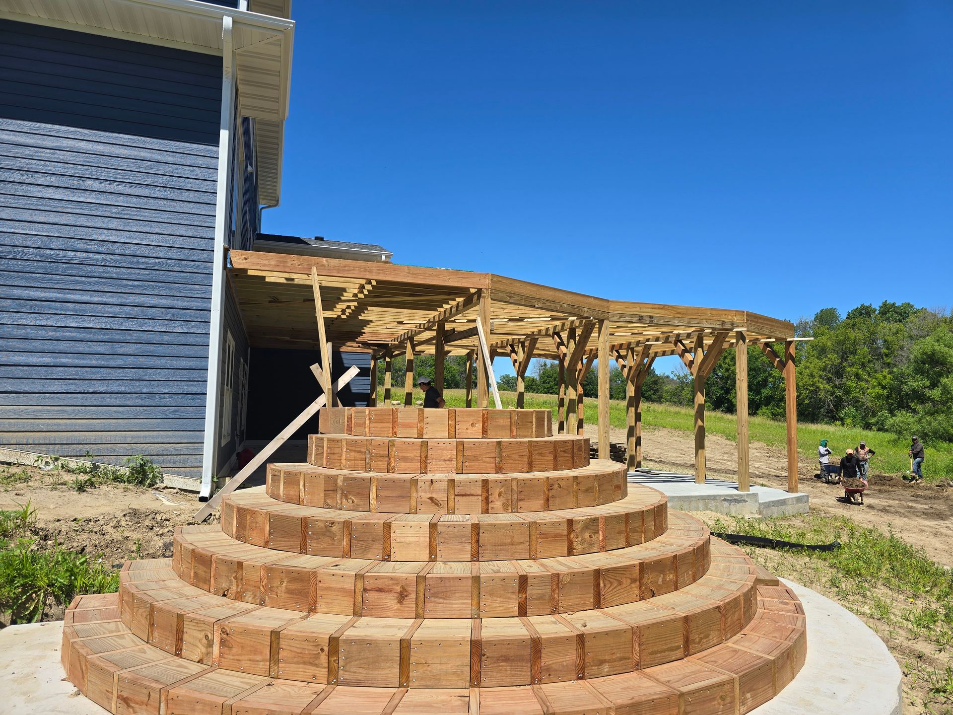 A brick staircase is being built in front of a house.