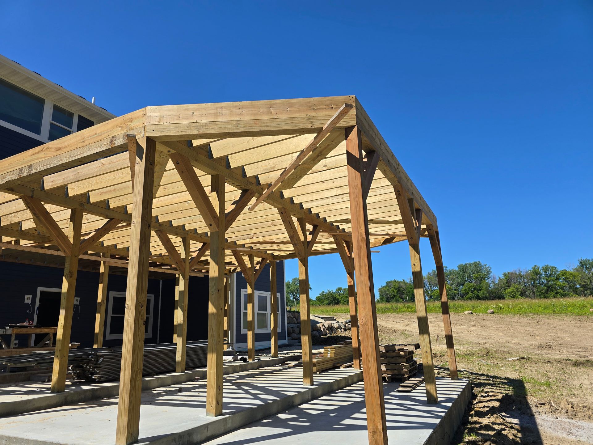 A wooden structure is being built in front of a house.