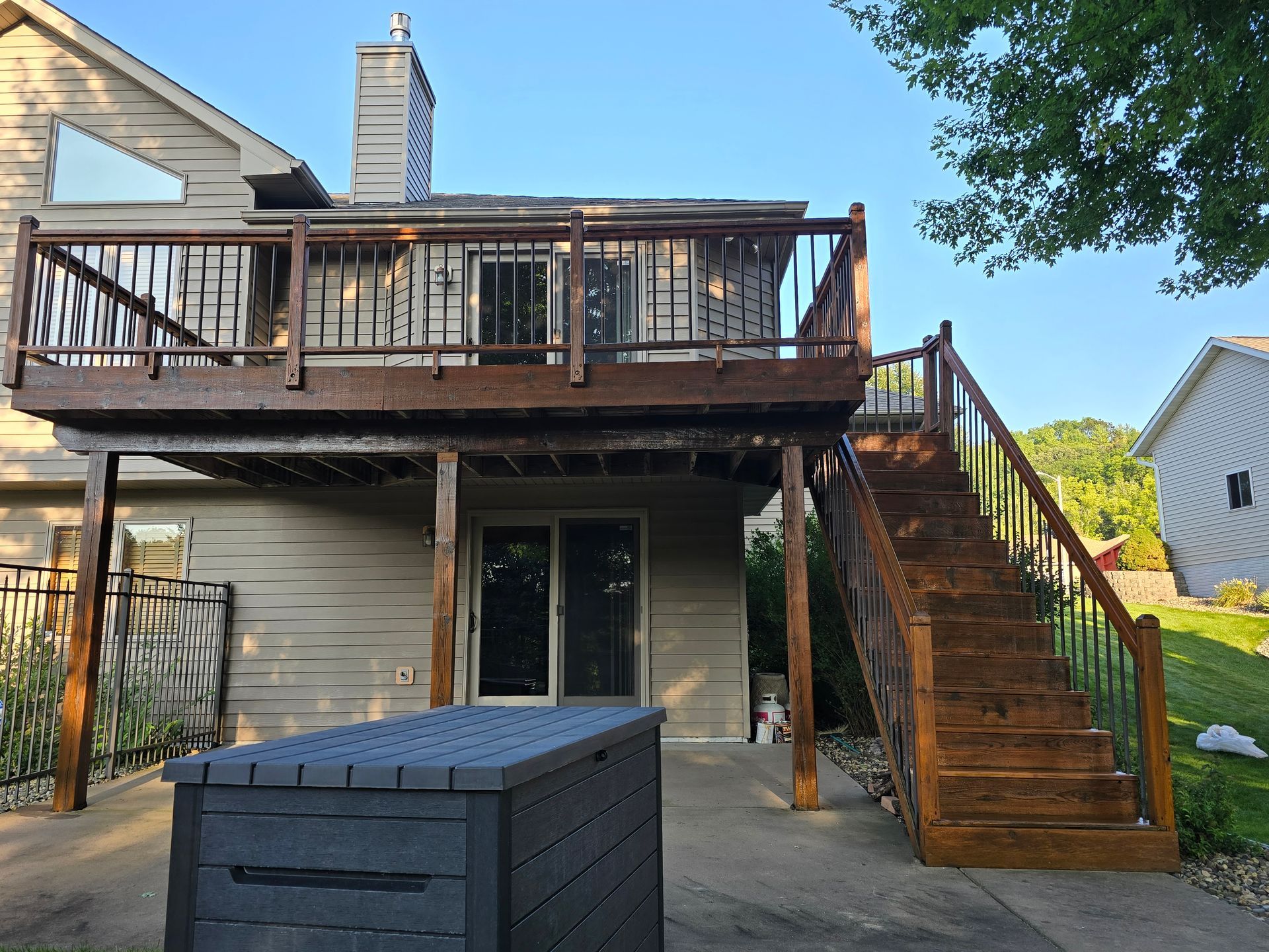 A house with a large deck and stairs leading up to it.