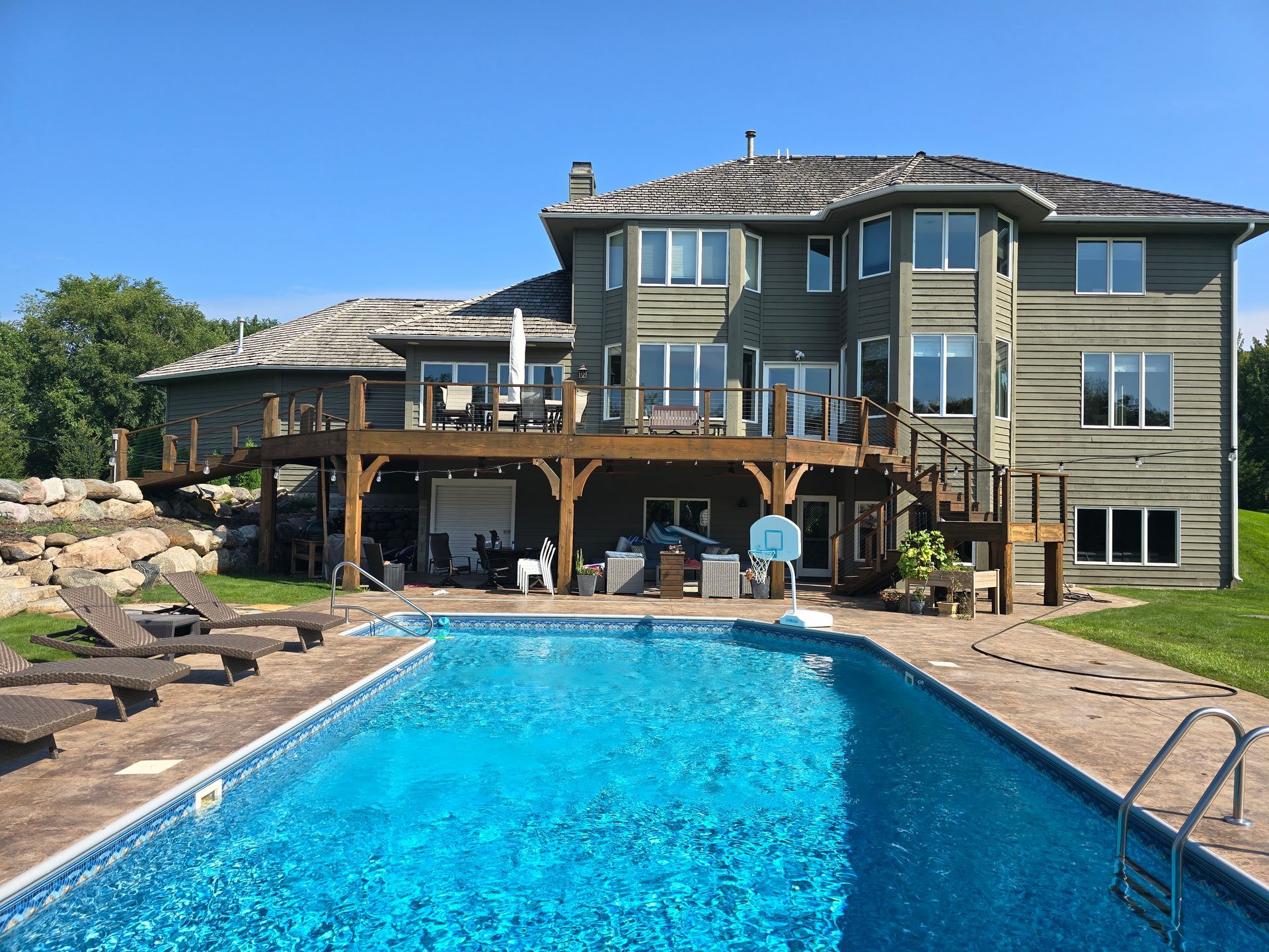 A large house with a large swimming pool in front of it
