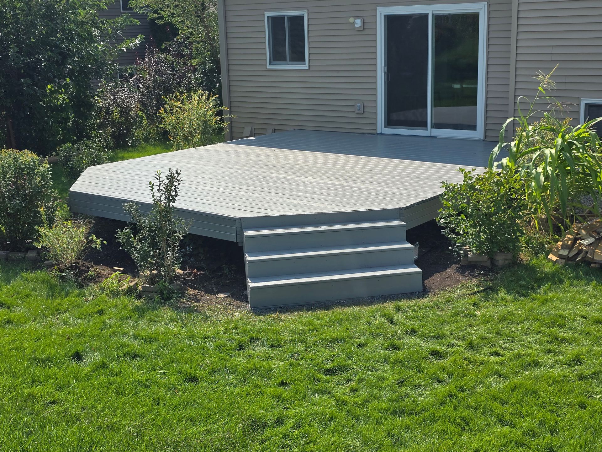 A patio with stairs in front of a house