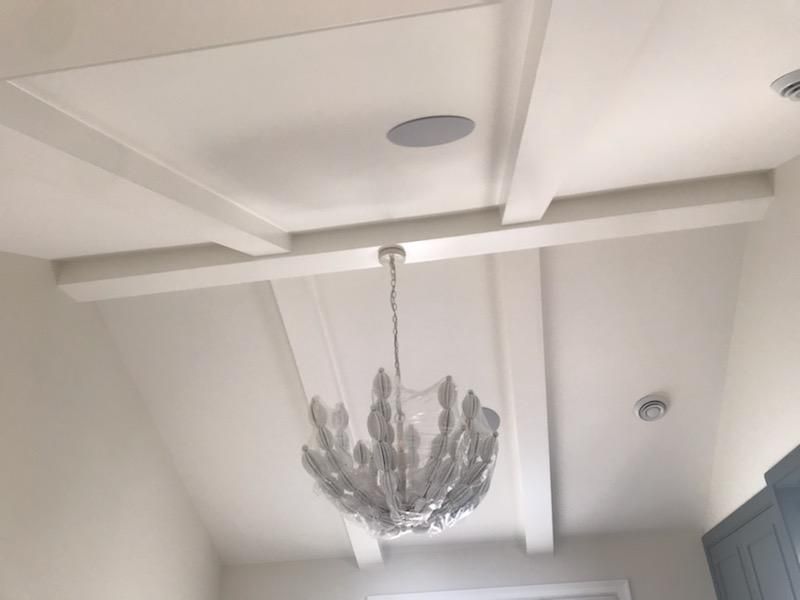 A chandelier is hanging from the ceiling of a room.