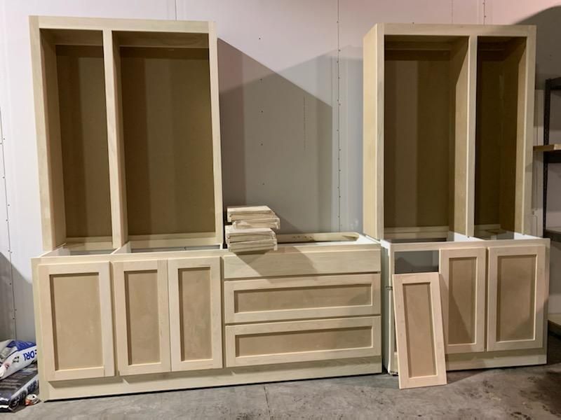 A bunch of cabinets are sitting on the floor in a room.