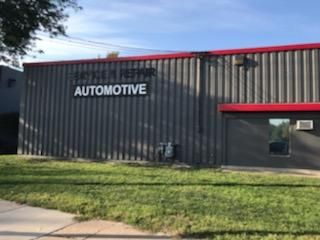 A large gray building with the word automotive on the side of it.