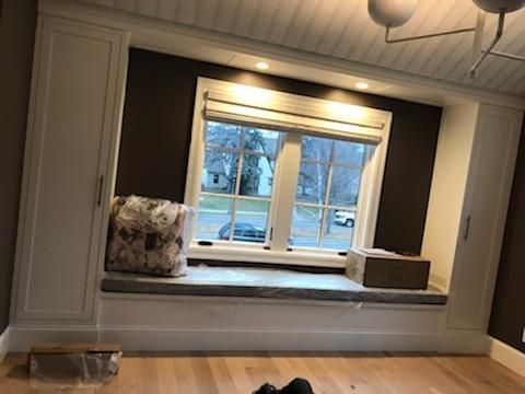 There is a window seat in the corner of the room.