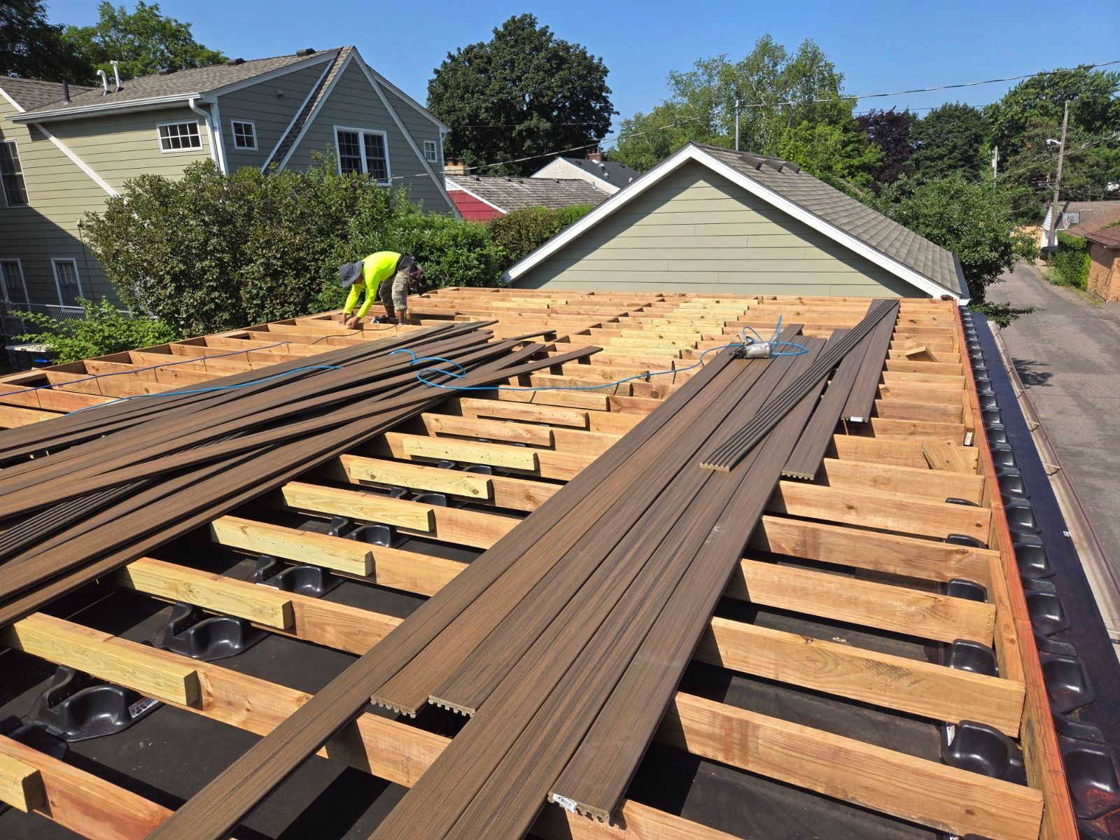 A man is working on the roof of a house.