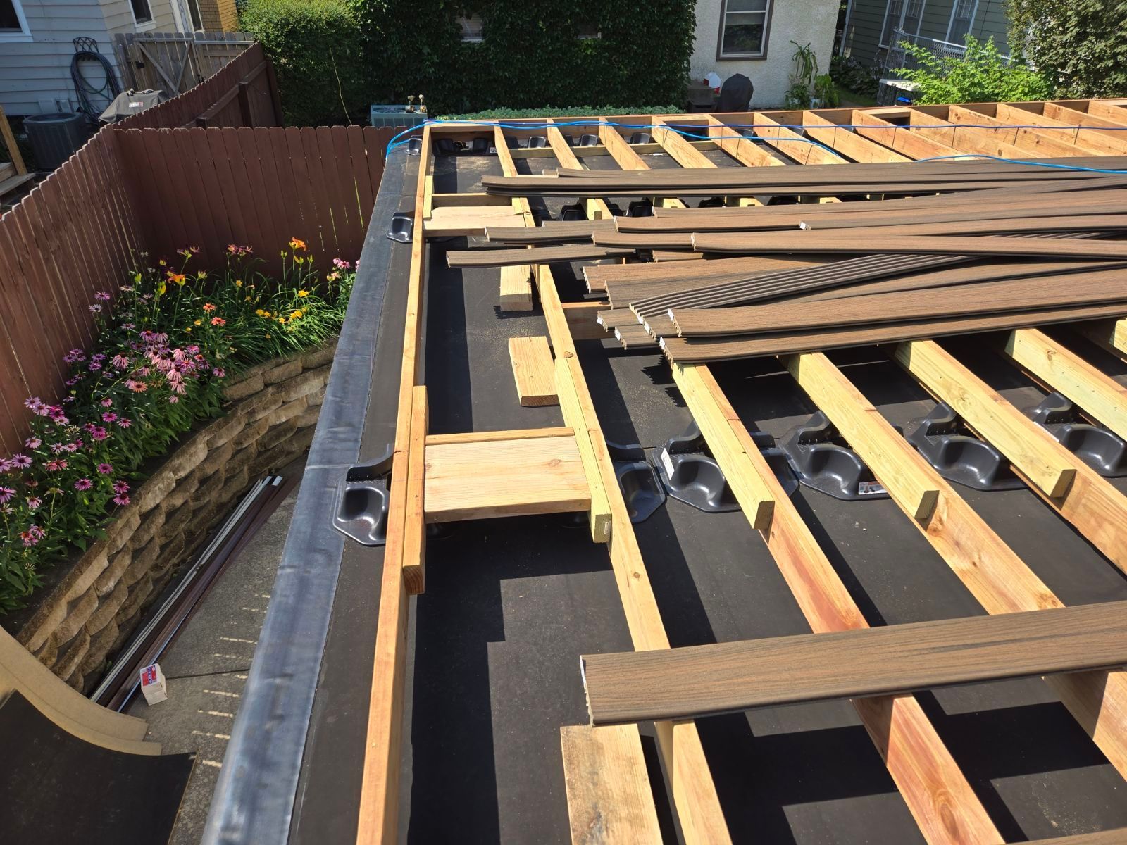 A wooden deck is being built on top of a roof.