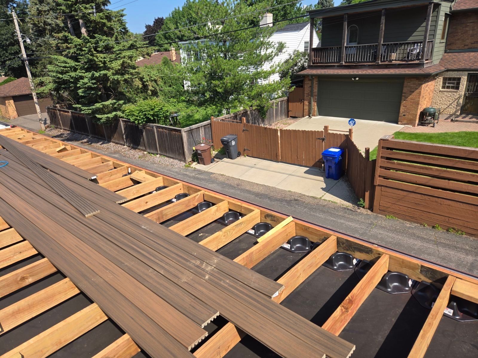 A wooden deck is being built in front of a house.