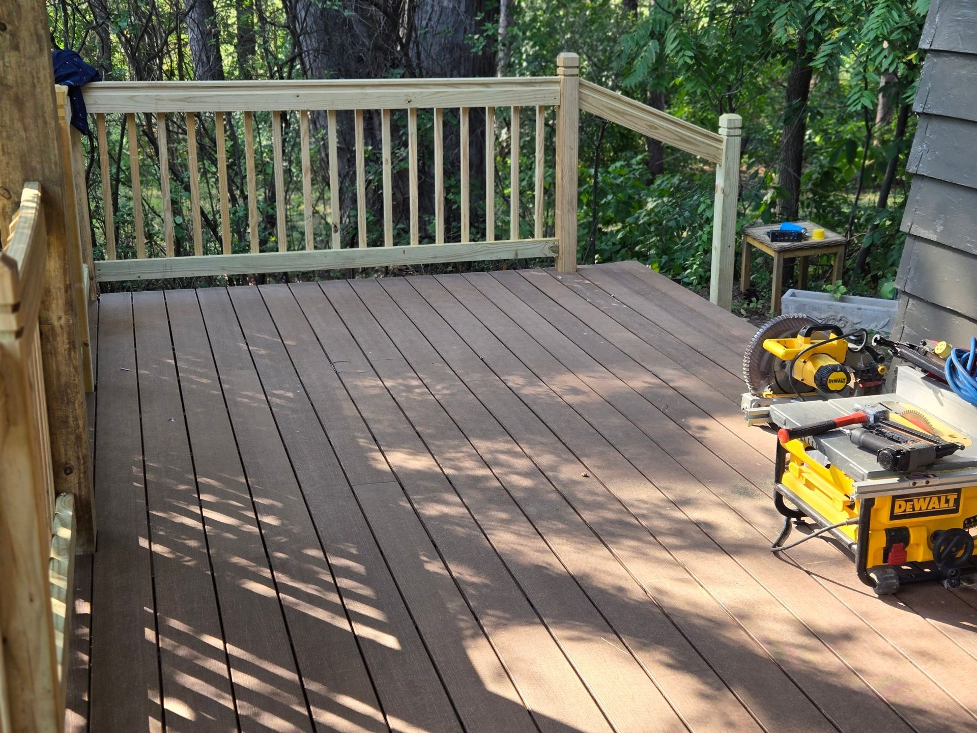 A wooden deck with a dewalt saw on it
