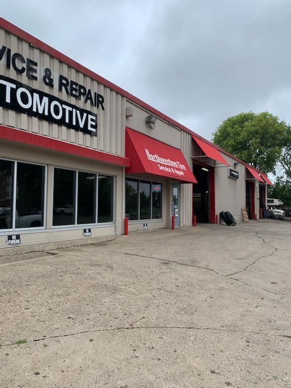 An automotive service and repair shop with a red awning