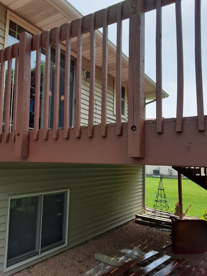 A wooden deck with stairs leading up to it