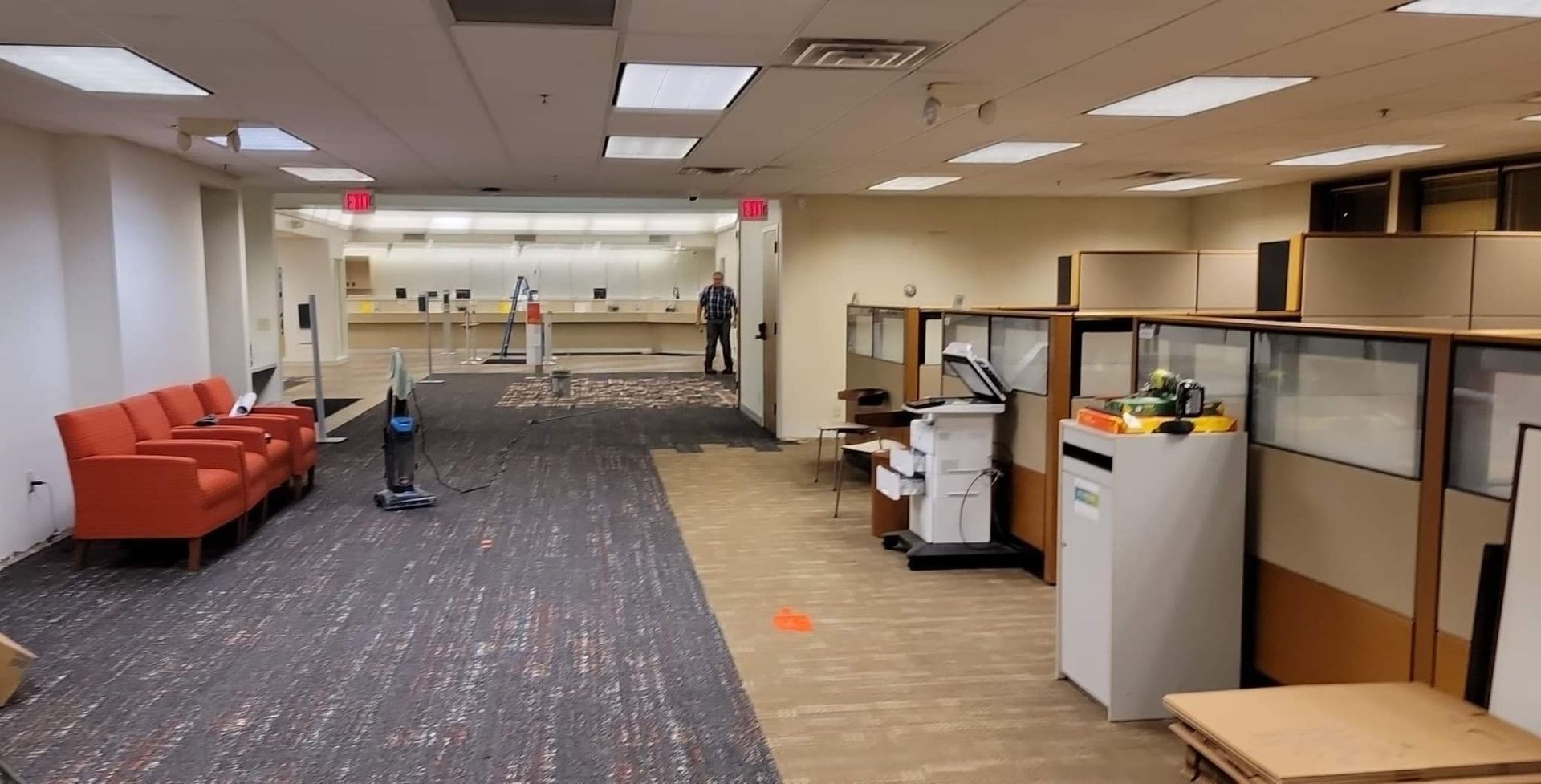 A large empty office with cubicles and chairs.