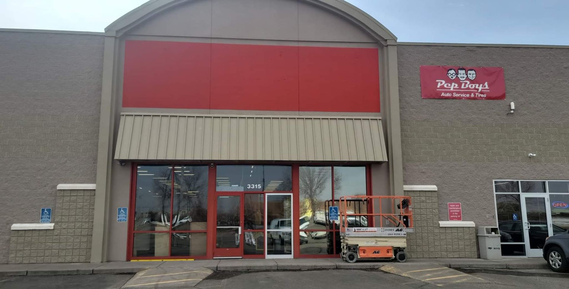 A large building with a red sign on the side of it.
