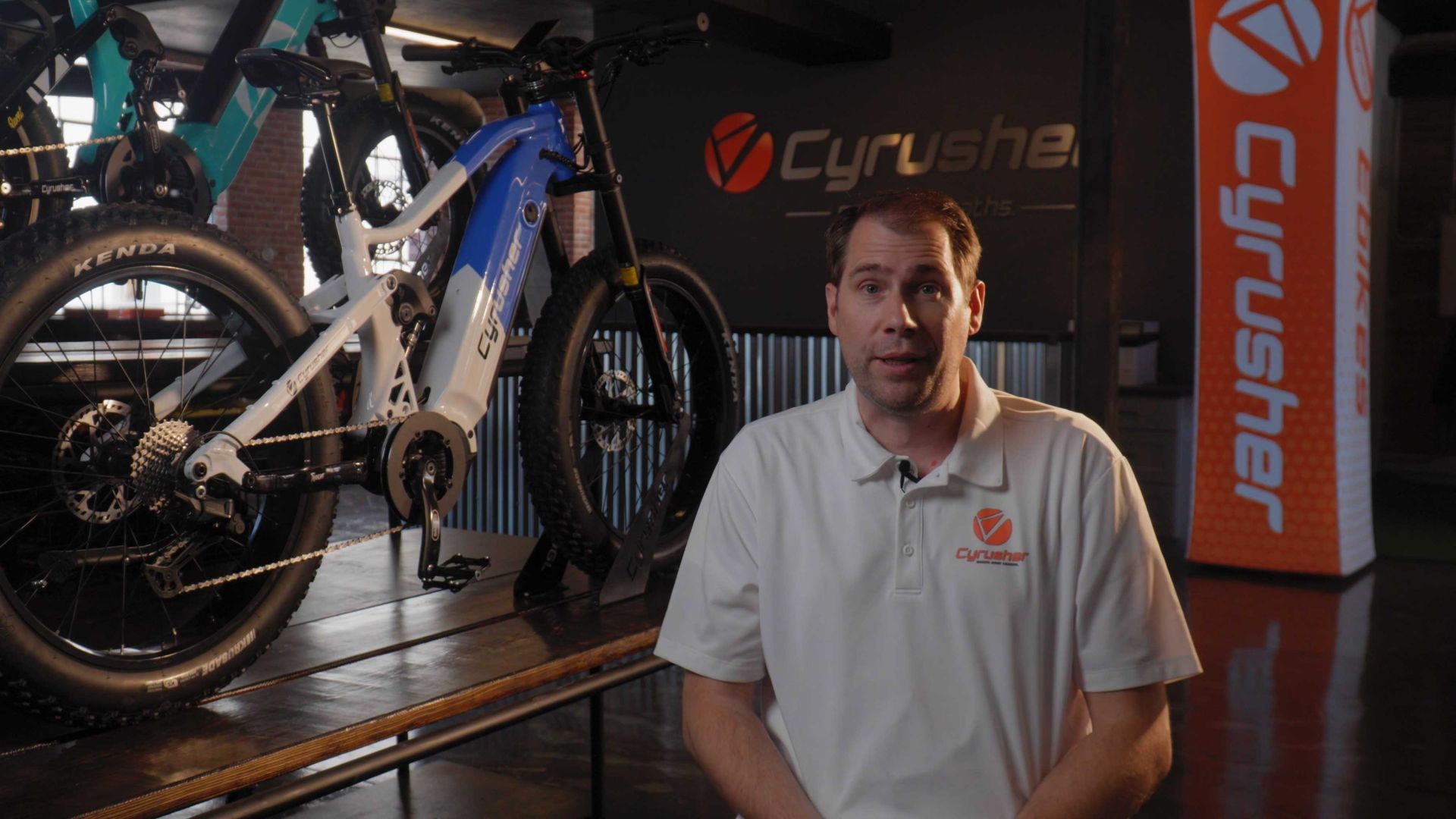 Store managers showcasing Cyrusher eBikes inside the new retail location.