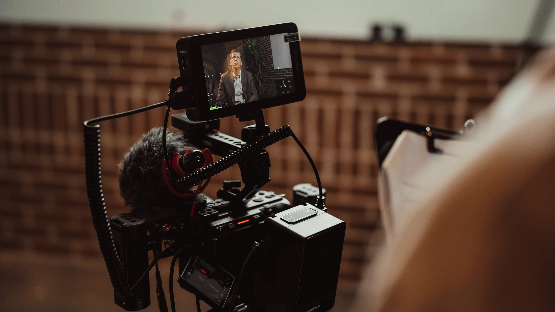 A man is standing in front of a video camera.