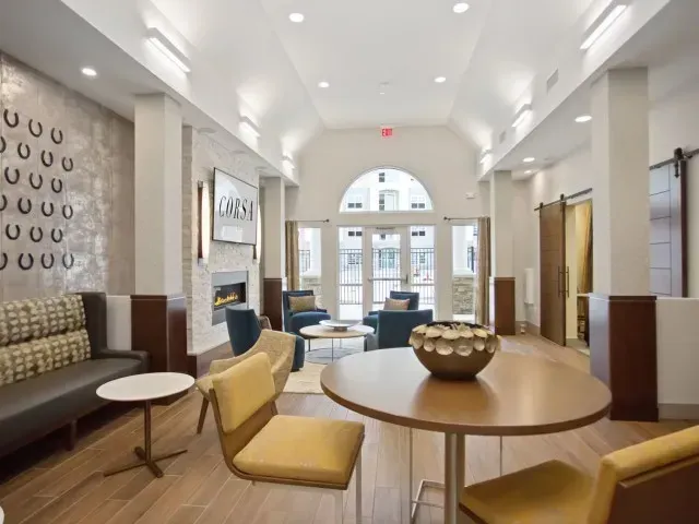 Corsa Tuscan Village apartment clubhouse entrance with ample social seating in Salem, NH.