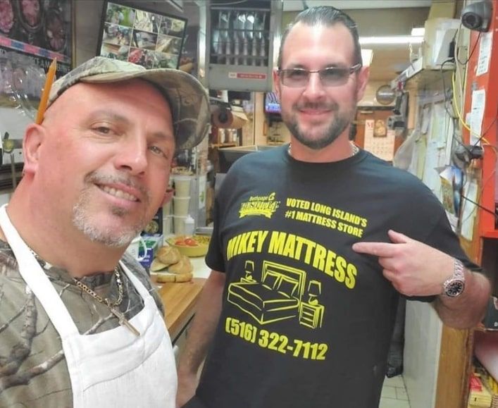 a man wearing a t-shirt that says mikey mattress
