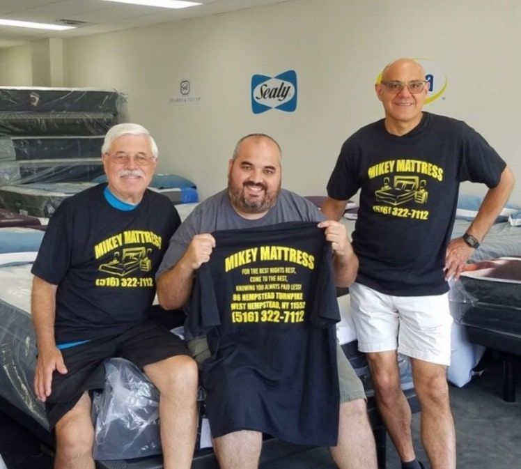 three men wearing shirts that say mikey mattress