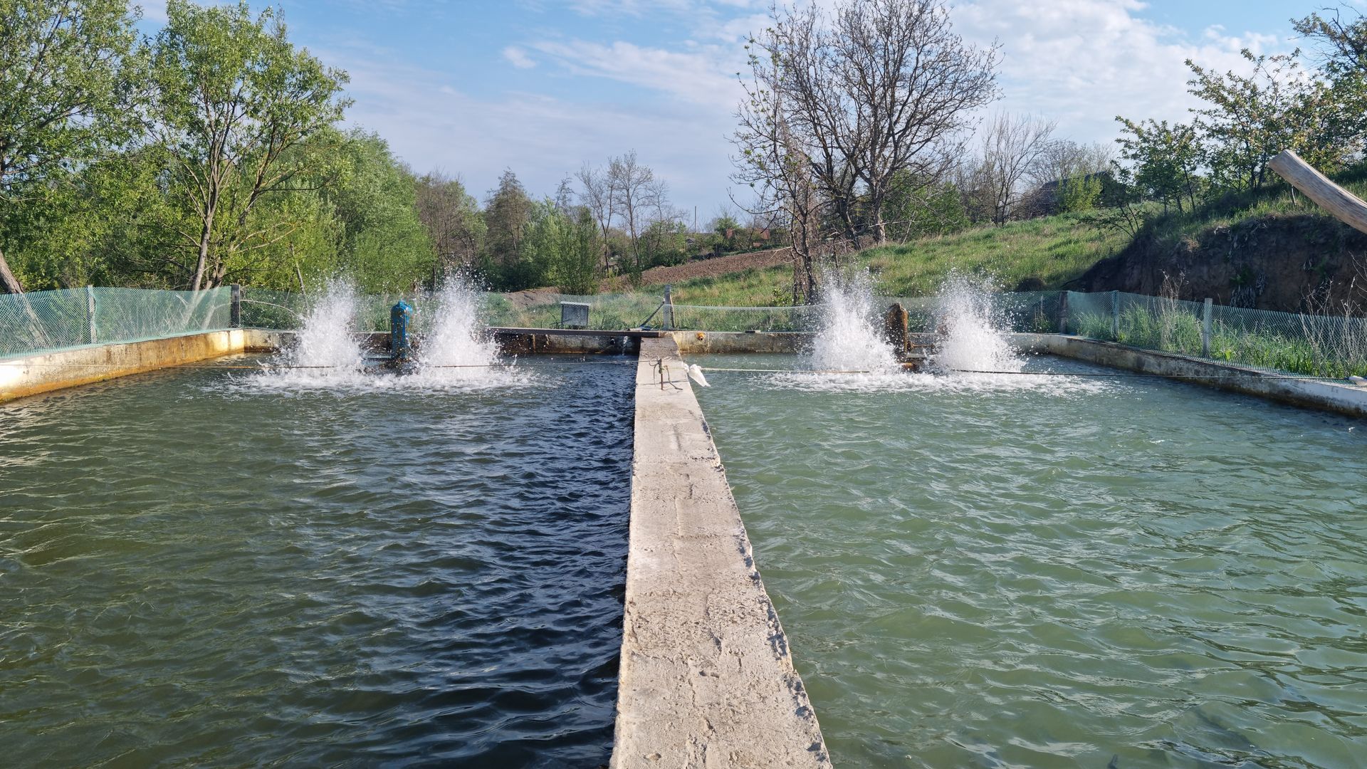 Two water tanks with aerators spraying water