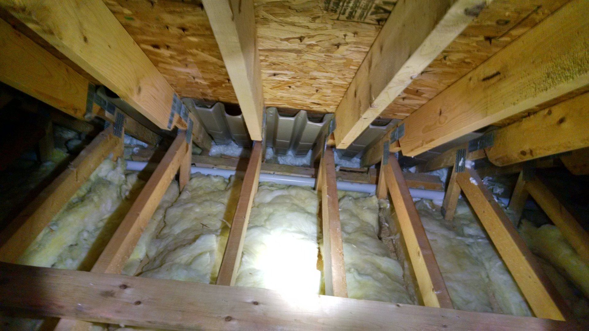 Newly installed foam insulation in an attic in Albany, NY