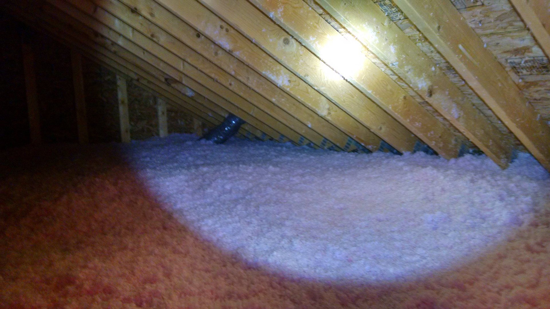 Foam sprayed in an attic to help ensure energy efficiency in Albany, NY