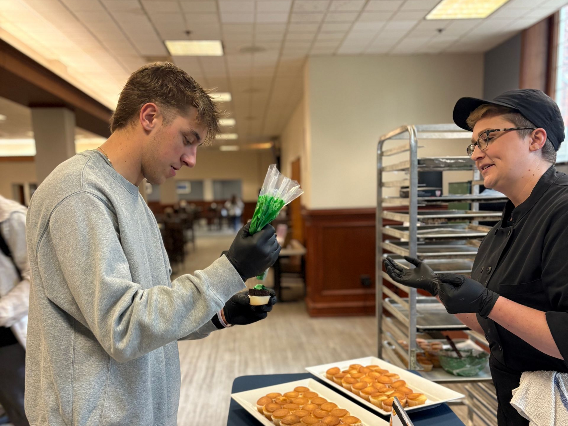 A group of chefs are posing for a picture in a kitchen.