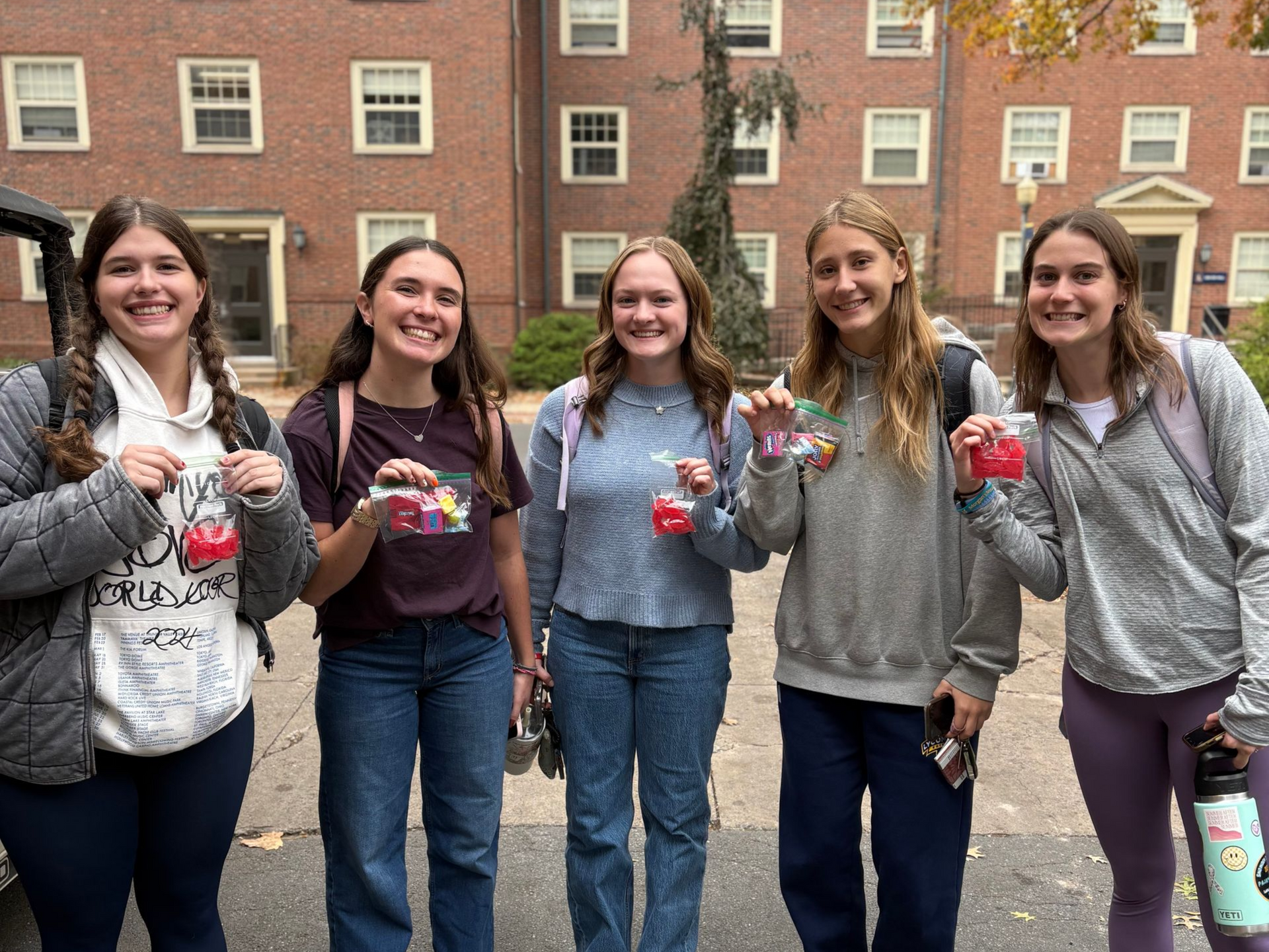 A large group of people are posing for a picture in a room.