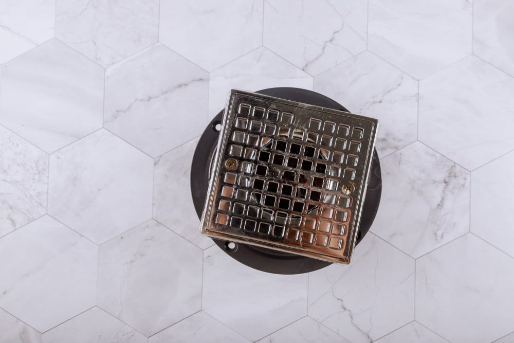 A Drain Is Sitting On Top Of A Marble Floor — Jobs2BDone in Woy Woy, NSW