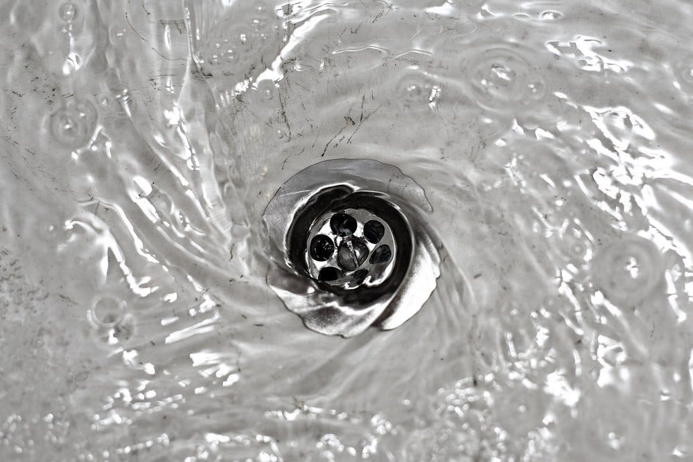 A Black And White Photo Of Water Running Down A Drain — Jobs2BDone in Woy Woy, NSW