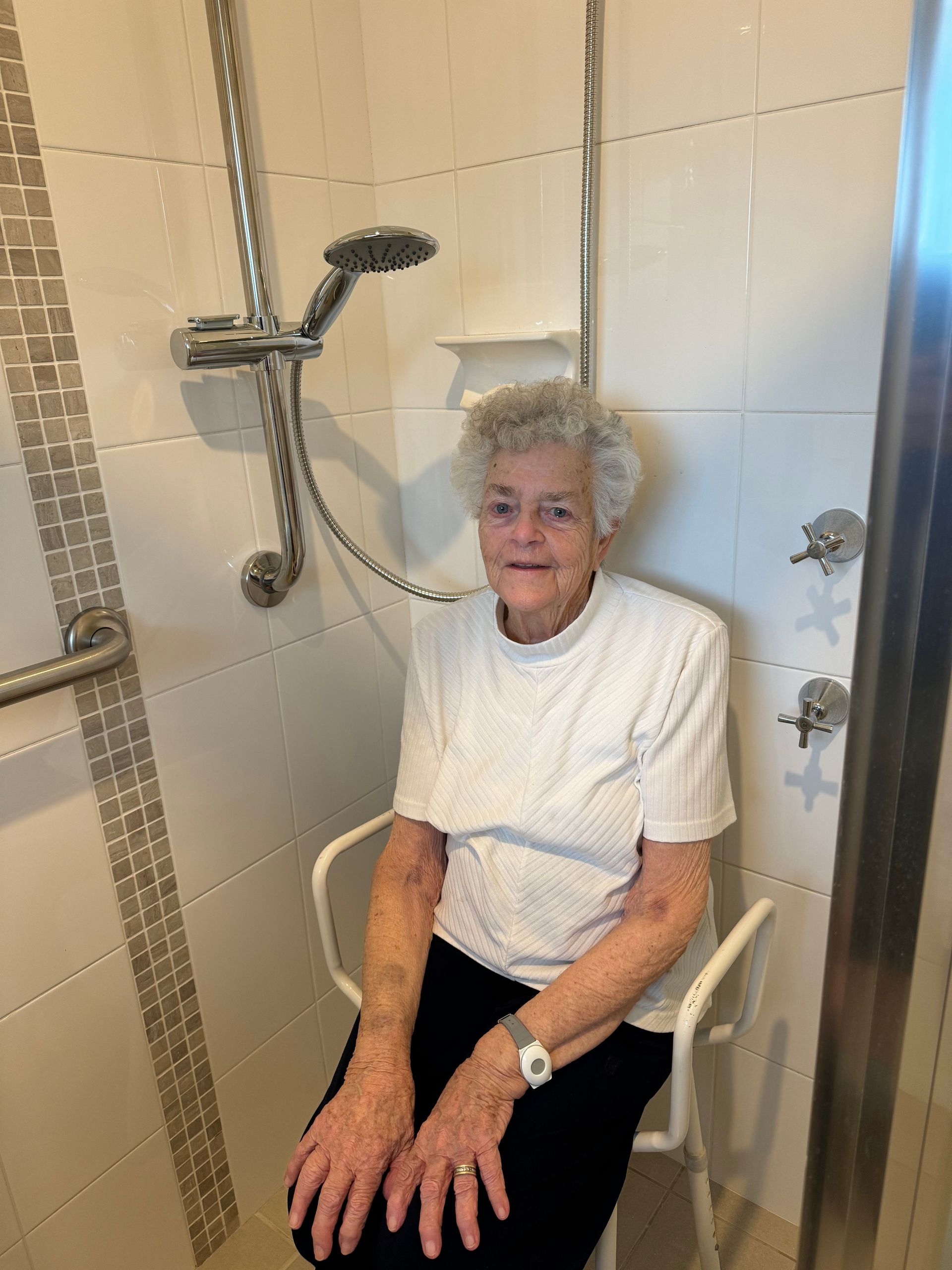 A Woman Is Sitting In A Modified Shower — Jobs2BDone in Woy Woy, NSW