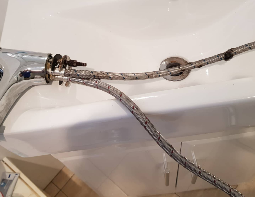 A bathroom sink with a hose attached to it — Jobs2BDone in Woy Woy, NSW