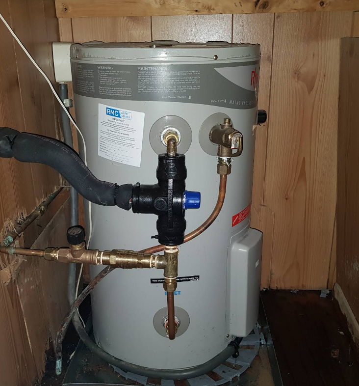 A Gray Water Heater Is Sitting On The Side Of A Building Next To A Window  — Jobs2BDone in Woy Woy, NSW