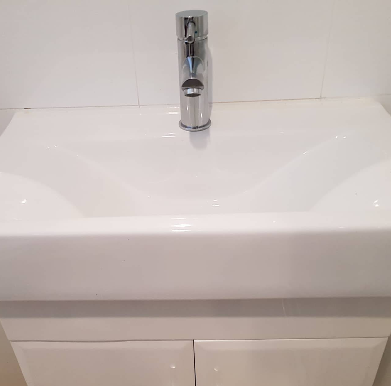 A white bathroom sink with a chrome faucet — Jobs2BDone in Umina, NSW