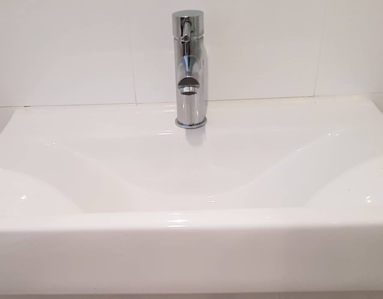 A Close Up Of A Kitchen Sink With A Chrome Faucet  — Jobs2BDone in Avoca Beach, NSW