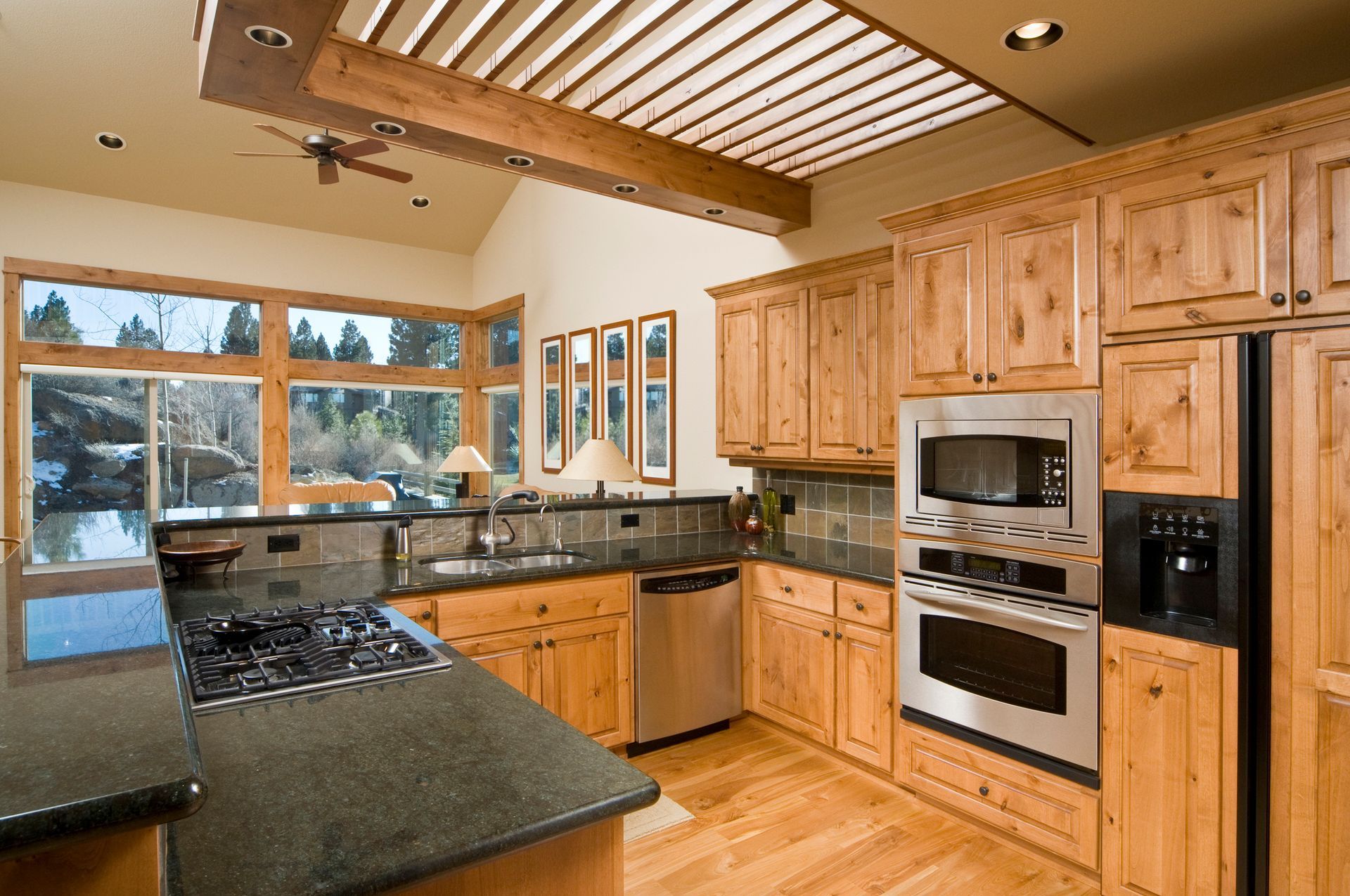 A kitchen with wooden cabinets and stainless steel appliances