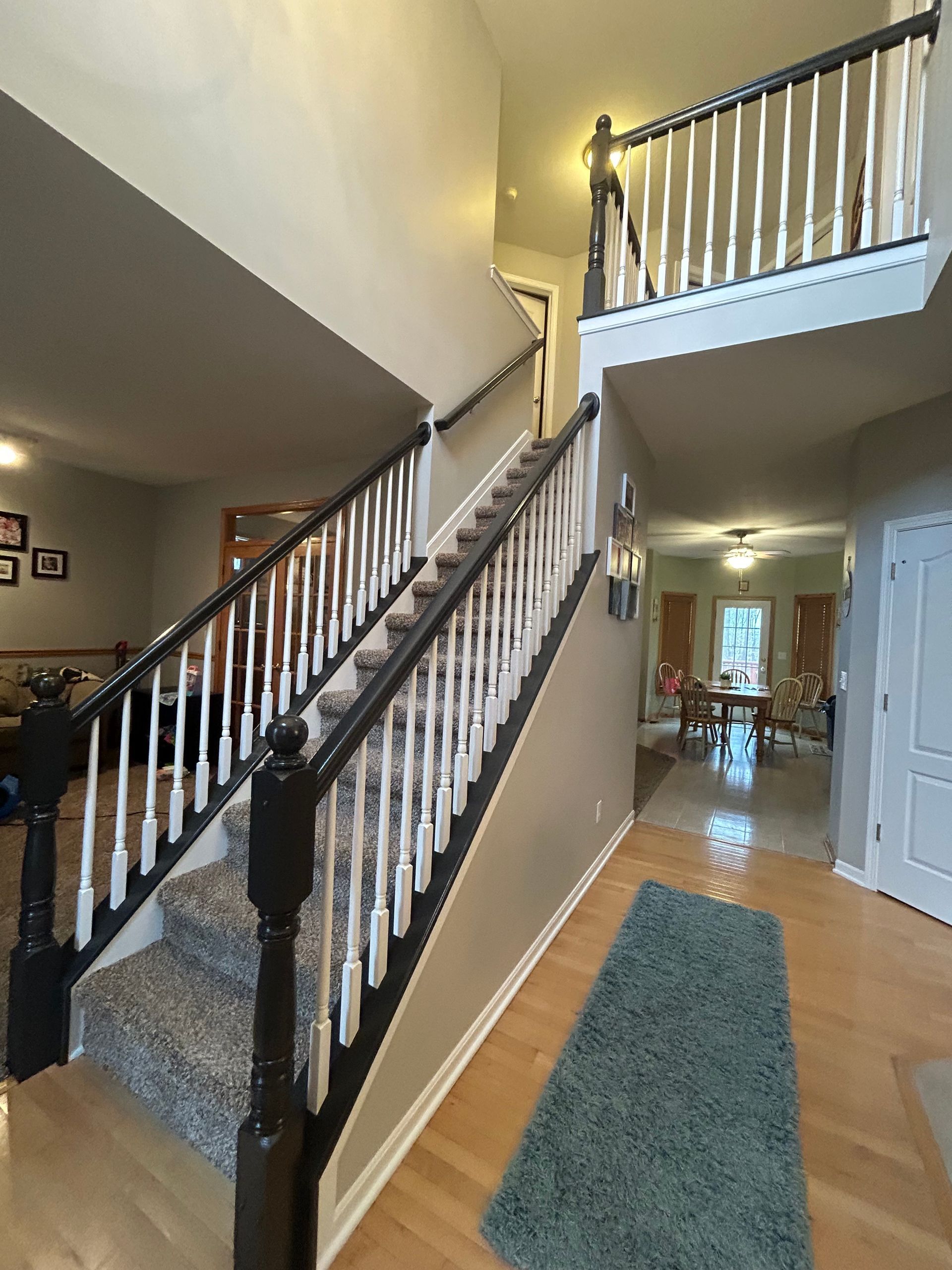 Stair railing refinishing from oak to black in Medina Ohio by Inspired Services & Painting