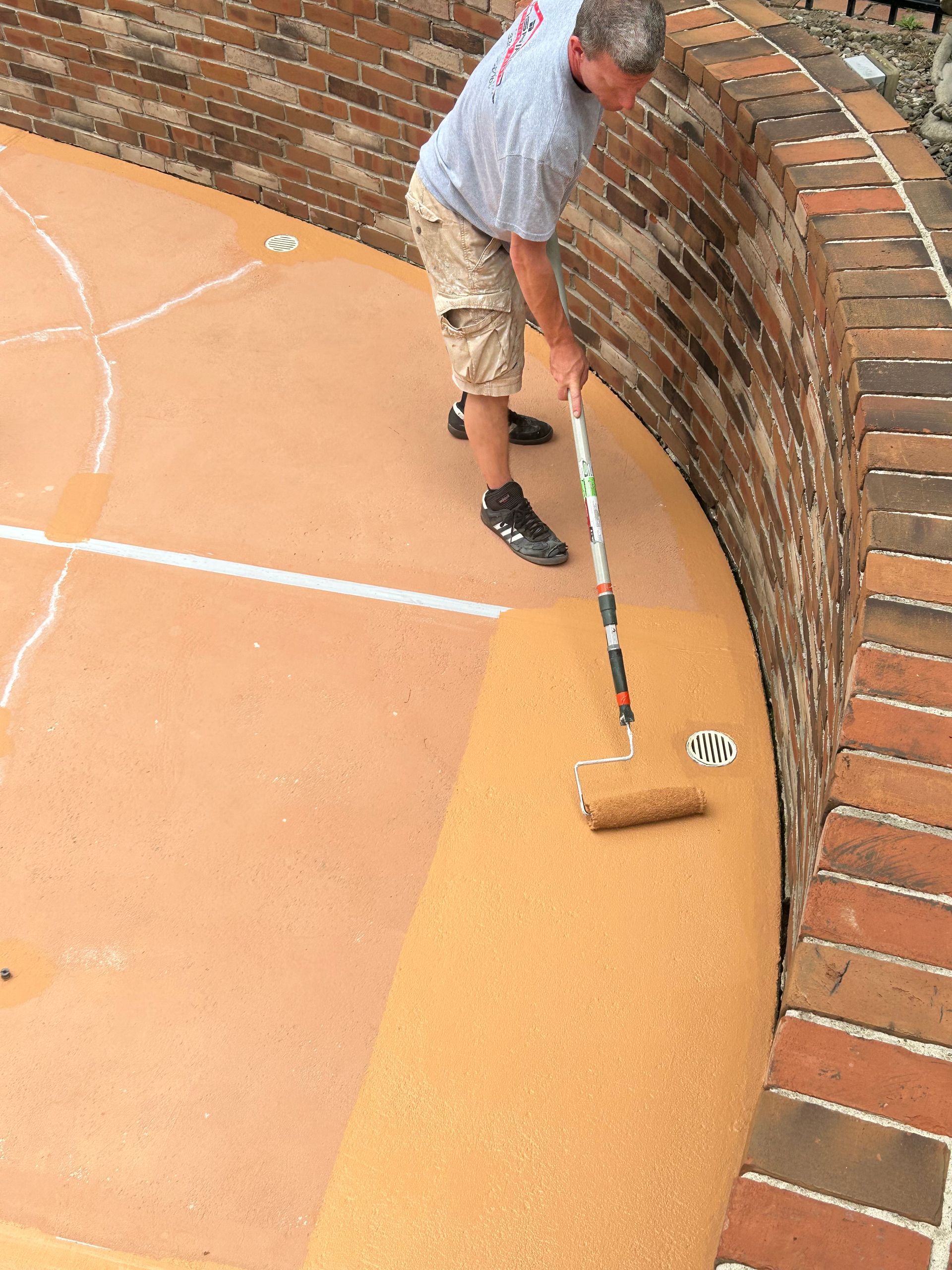 Pool deck painting and crack repair in Bath Ohio by Inspired Services & Painting