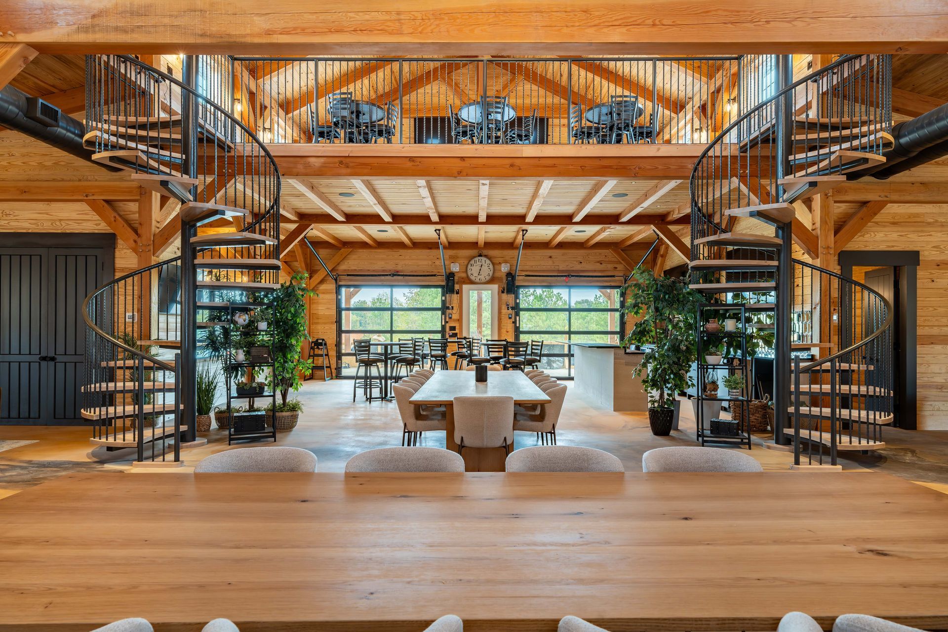 A large wooden house with a spiral staircase leading to the second floor.