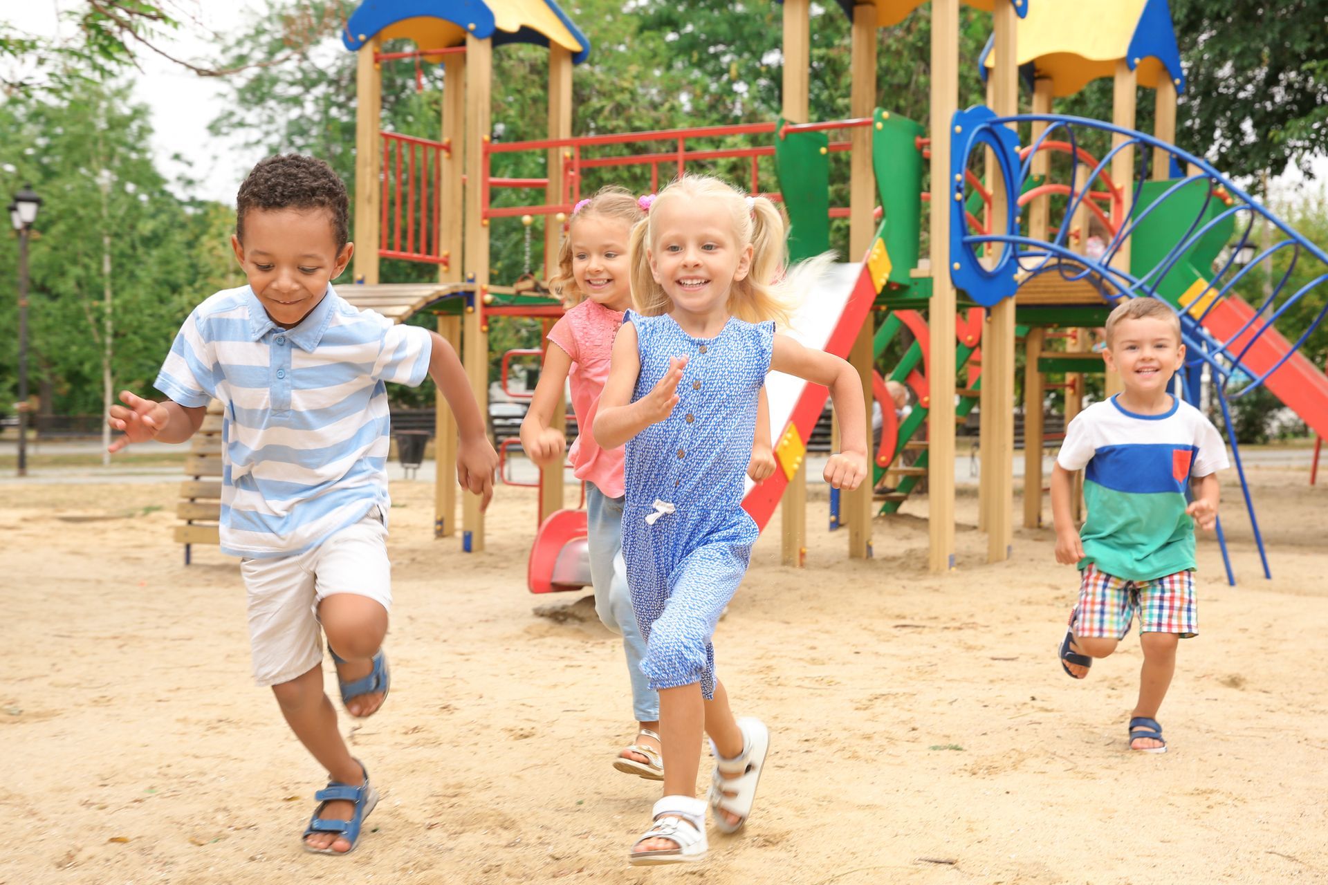 A group of children are running in a playground.