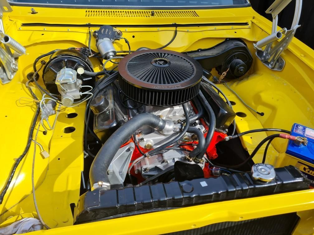 A ford engine with a fan attached to it