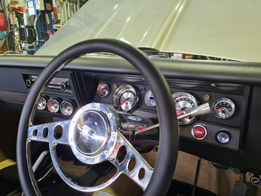 A close up of a steering wheel and dashboard of a car.