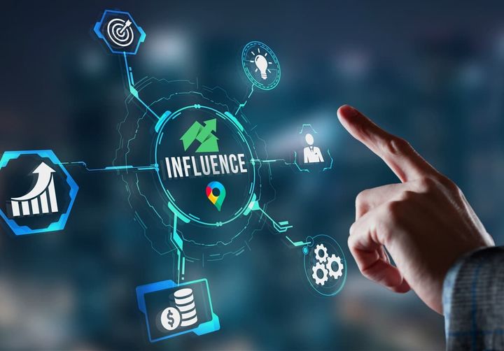 A person is pointing at a screen with the word influence on it.