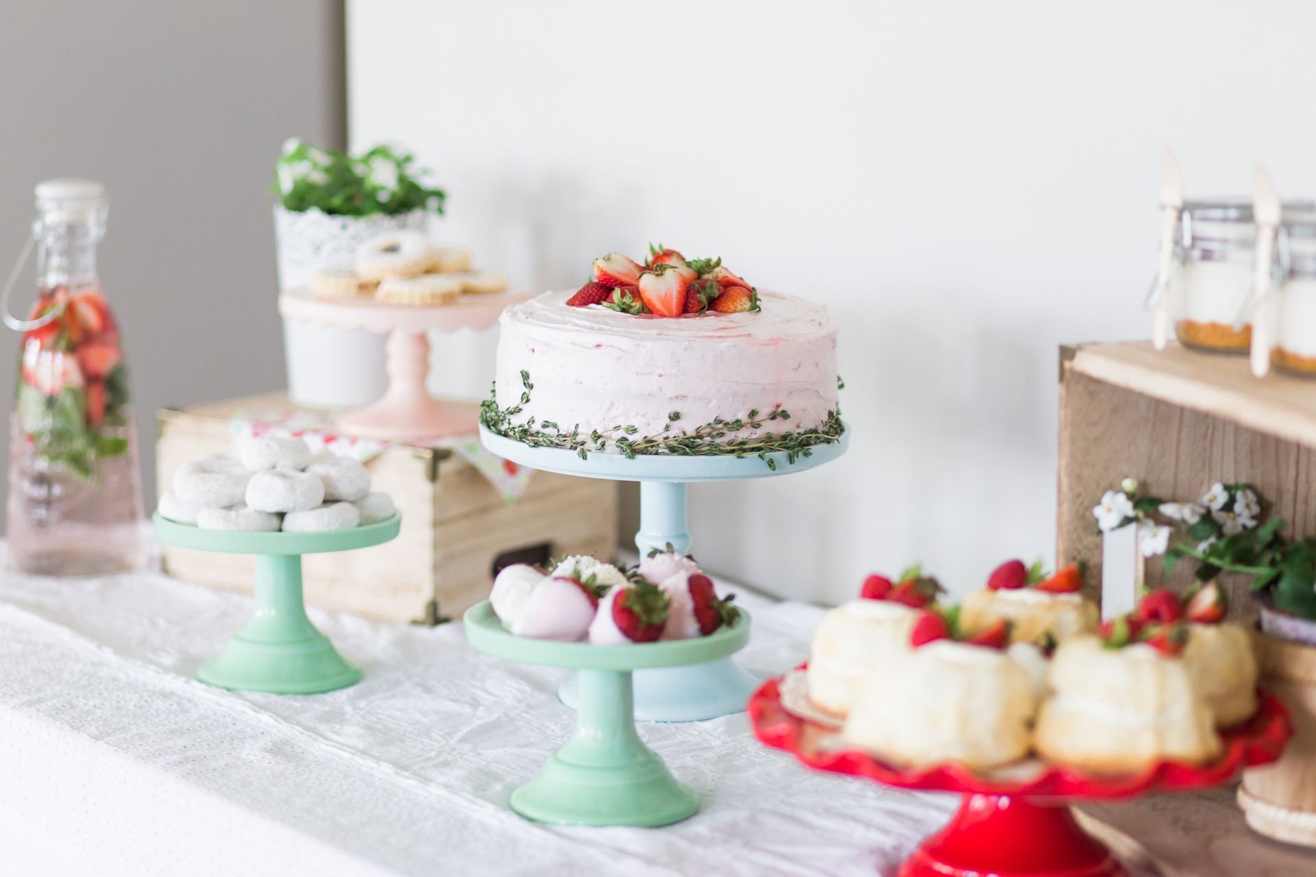 an assortment of strawberry desserts on a beautifully decorated table