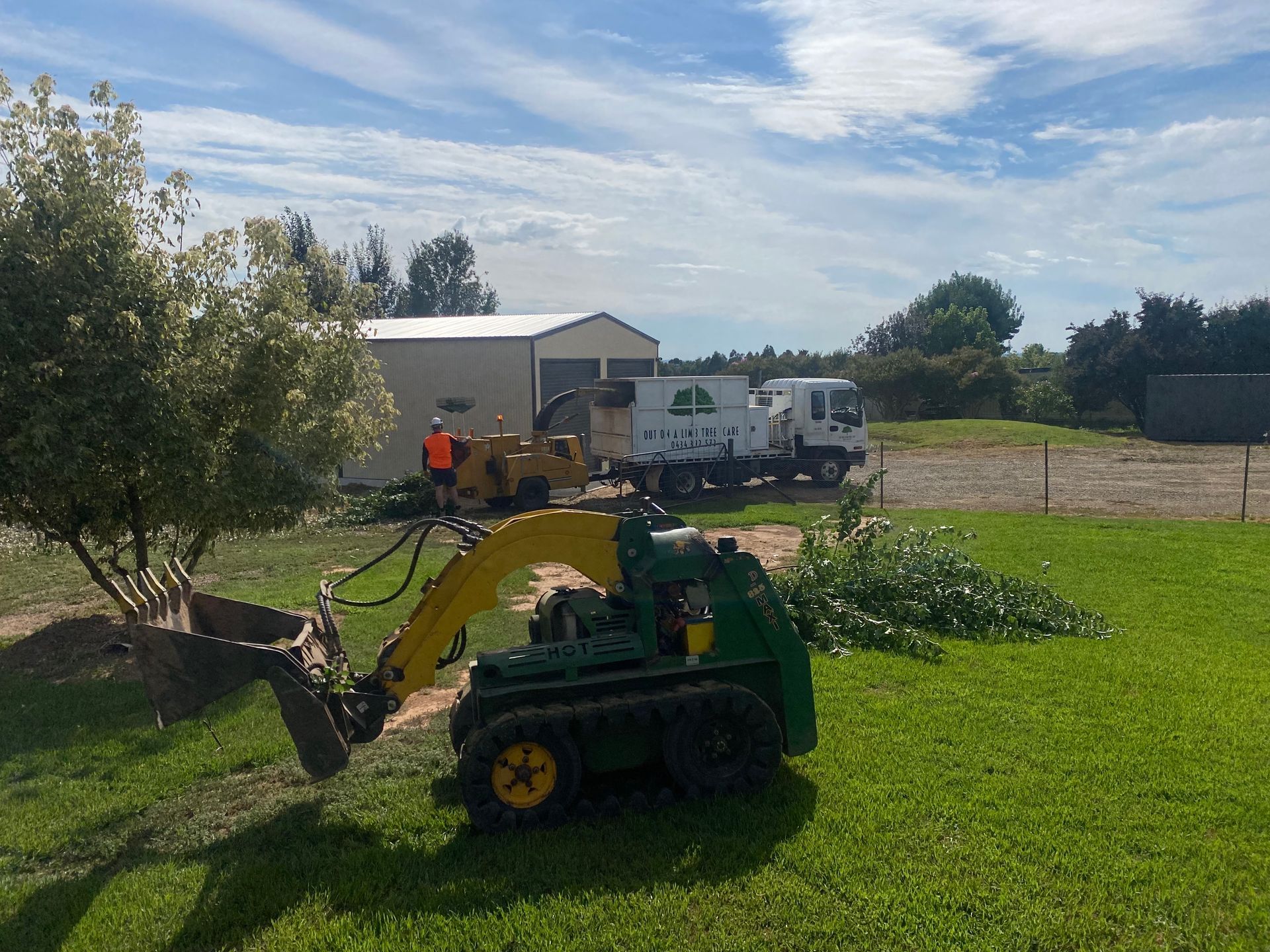 A Man Is Cutting A Hedge With A Chainsaw — Out On A Limb Tree and Garden Care In Batemans Bay, NSW