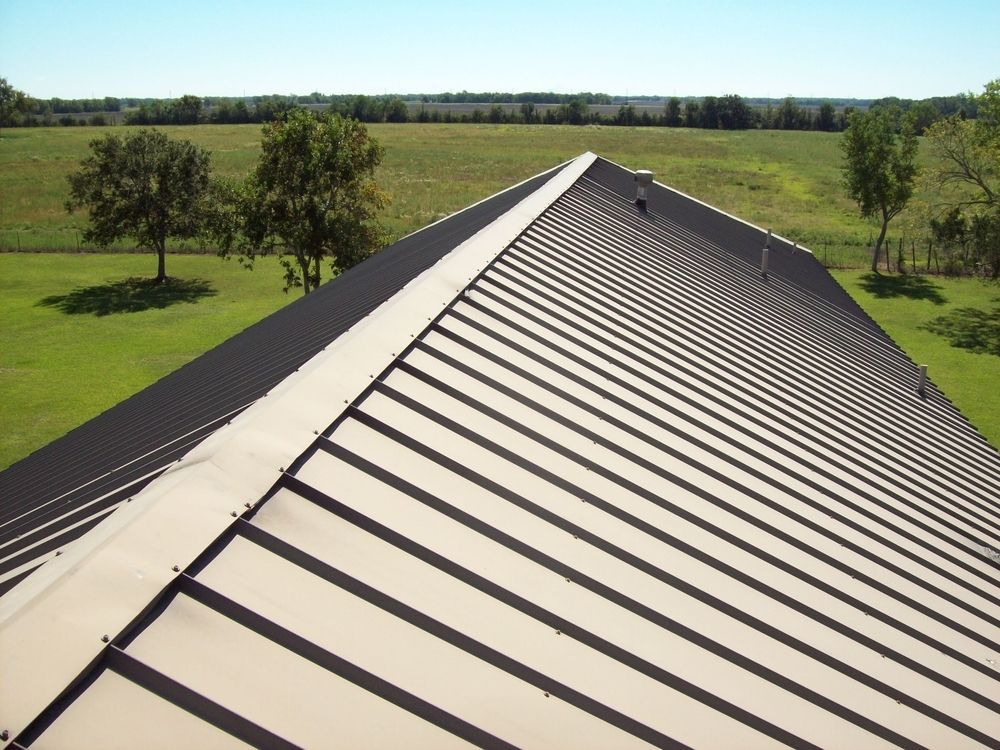 A Roof With A Blue Tarp On It And A Lot Of Tiles On It — ACT Roofing in Ngunnawal, ACT