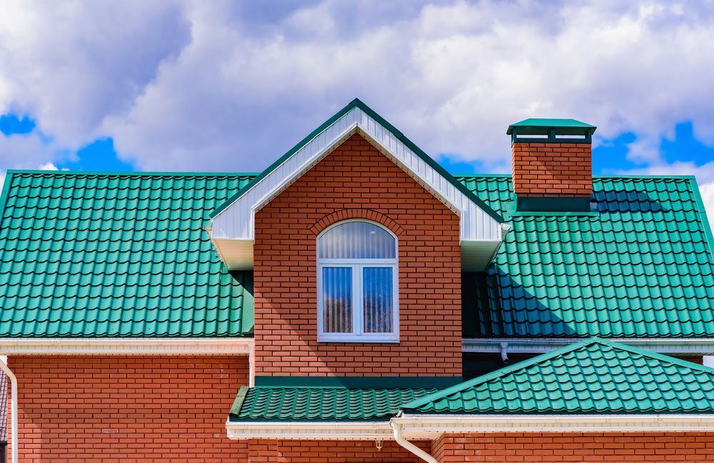 Freshly Painted Green Roof Featuring A Chimney — ACT Roofing in Tuggeranong, ACT